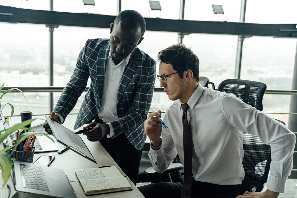 Two business professionals reviewing documents together in an office